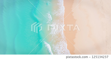 Aerial view of tropical turquoise ocean waves touching soft sand beach with smooth gentle sea foam and bright light Aerial view of tropical turquoise ocean waves touching soft sand beach with smooth gentle sea foam and bright light 125134237