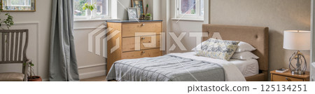 Modern cozy bedroom interior with sunlight soft neutral tones wooden furniture bed pillows curtain lamp morning home inspiration 125134251
