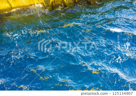 dock, surf, blue water 125134907