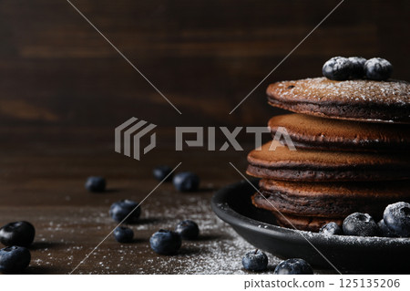Chocolate pancakes, tasty breakfast, concept of delicious food, space for text 125135206