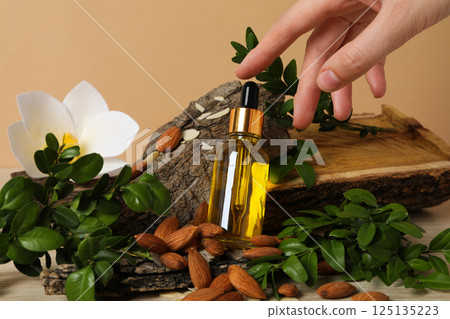 Almonds oil, concept of different cosmetic and skin care accessories Almonds oil, concept of different cosmetic and skin care accessories 125135223