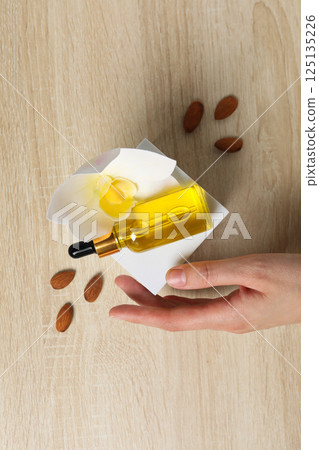 Almonds oil, concept of different cosmetic and skin care accessories 125135226