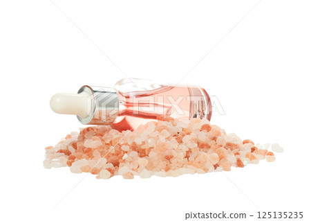 Serum bottle on pink sea salt on white background, close up 125135235