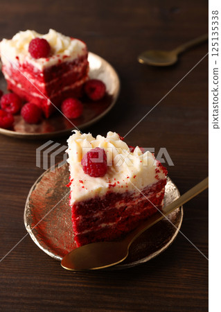 Pieces of red velvet cake on plates on wooden background, close up 125135338