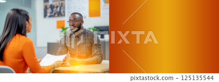 A job candidate standing confidently in front of an HR representative, symbolizing recruitment and talent acquisition. The vibrant orange background adds energy to the scene 125135544