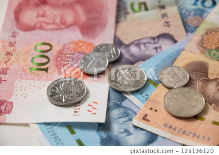 Many of different Chinese yuan banknotes. Chinese paper currency Yuan renminbi banknotes and coins as background. 125136120