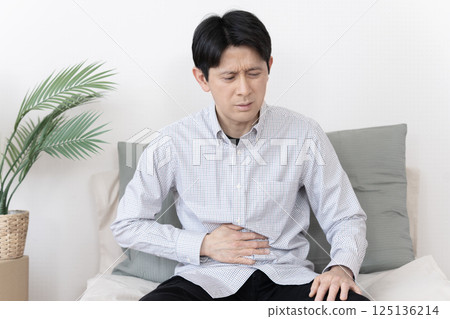 Man with stomach ache, stomach ache, gastroenteritis, diarrhea, constipation 125136214