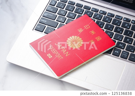 Image of someone preparing a Japanese passport (10-year regular passport, red) and planning a trip abroad 125136838