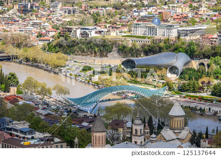 Peace bridge, steel and glass construction pedestrian bridge over Kura Mtkvari river in central Tbilisi, Georgia Peace bridge, steel and glass construction pedestrian bridge over Kura Mtkvari river in central Tbilisi, Georgia 125137644