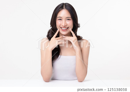 Beauty portrait of happy Asian female face with natural skin make up isolated on white background. Beauty portrait of happy Asian female face with natural skin make up isolated on white background. 125138038