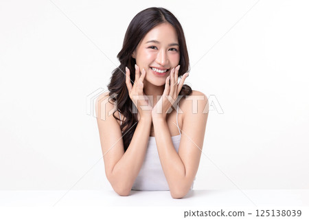 Beauty portrait of happy Asian female face with natural skin make up isolated on white background. Beauty portrait of happy Asian female face with natural skin make up isolated on white background. 125138039