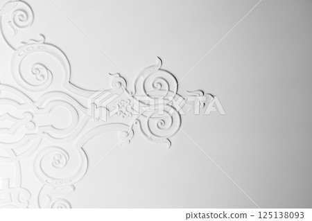 White ceiling plaster relief showcasing elegant floral and ornament 125138093