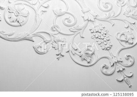 White plaster relief showcasing elegant floral and ornamental designs 125138095