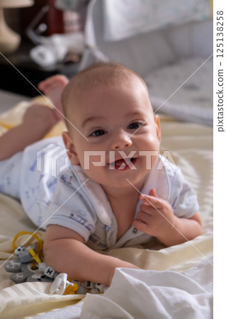 Happy Baby Playing with Toys on a Blanket Happy Baby Playing with Toys on a Blanket 125138258