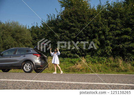 Woman Relaxing on SUV in Nature 125138265