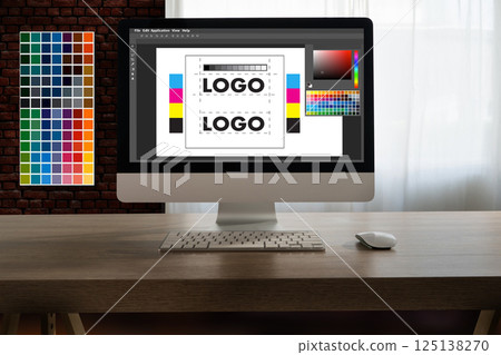 A creative woman sits at her desk using a tablet, drawing digital art for a web design agency with  125138270