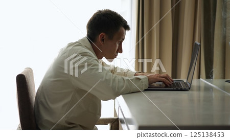 Man hands move rapidly on keyboard while eyes fixed on screen 125138453