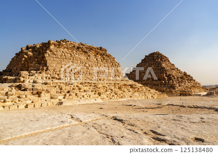 Pyramids of Egypt showcase ancient architecture against clear blue sky in daylight 125138480