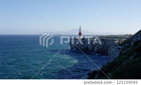 Europa Point Lighthouse guiding ships near Gibraltar, United Kingdom, with Morocco in the background Europa Point Lighthouse guiding ships near Gibraltar, United Kingdom, with Morocco in the background 125139593