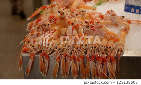 Fresh Norway Lobsters Lying on Ice in Fish Market 125139608