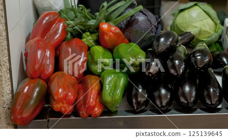 Colorful mix of fresh vegetables laying on a market stall, ready to be sold 125139645