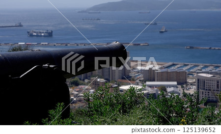Cannon overlooking Gibraltar Bay and city with ships sailing in the distance 125139652
