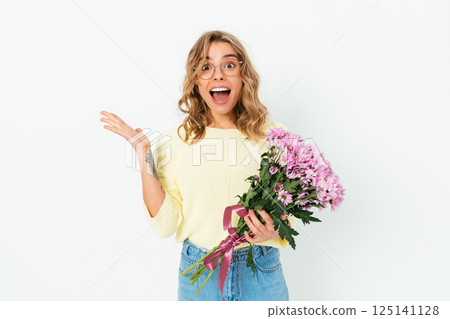 A woman is holding a bouquet of pink flowers and is smiling A woman is holding a bouquet of pink flowers and is smiling 125141128