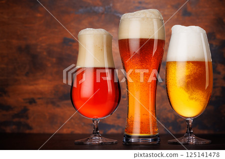 A selection of various beer glasses filled with different types of beer A selection of various beer glasses filled with different types of beer 125141478