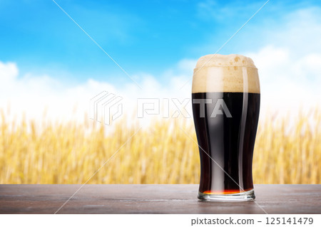A glass of stout beer with a frothy head A glass of stout beer with a frothy head 125141479