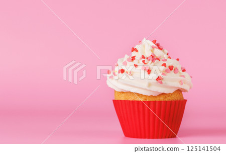 Festive cupcake topped with swirled frosting Festive cupcake topped with swirled frosting 125141504
