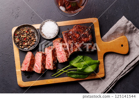 A perfectly cooked sliced striploin steak with a juicy, tender texture A perfectly cooked sliced striploin steak with a juicy, tender texture 125141544