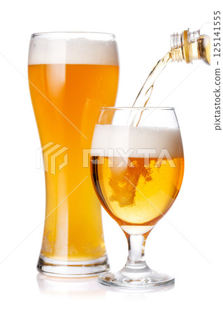 A glass of beer with a golden hue and frothy head, isolated on a clean white background A glass of beer with a golden hue and frothy head, isolated on a clean white background 125141555