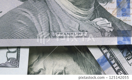 A closeup shot showcases US currency prominently featuring the notable figure Benjamin Franklin 125142055