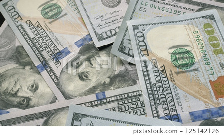 Closeup image of American Dollar Bills thoughtfully Piled Together in a neat manner 125142126