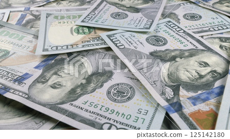 A CloseUp of American Dollar Bills Spread Out on a Surface for Detailed Viewing and Analysis 125142180