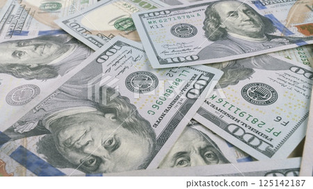 CloseUp of Neatly Stacked U.S. Dollar Bills Displaying Their Intricate Designs and Details CloseUp of Neatly Stacked U.S. Dollar Bills Displaying Their Intricate Designs and Details 125142187