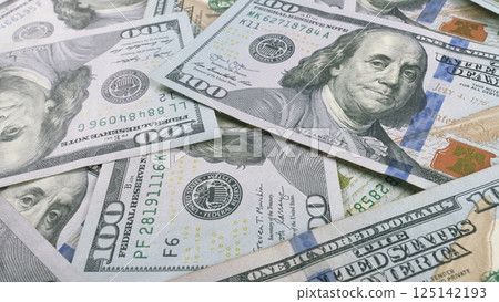 A closeup view showcasing Various U.S. Dollar Bills neatly arranged on a Table surface 125142193