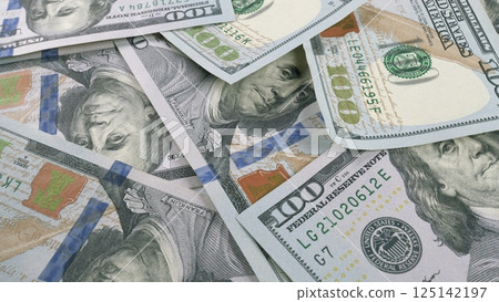 A visually striking display of Stacked Hundred Dollar Bills resting on a flat Surface A visually striking display of Stacked Hundred Dollar Bills resting on a flat Surface 125142197