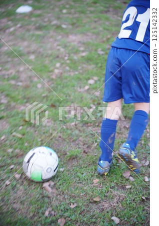 Young Soccer Player Kicking Ball During Match Young Soccer Player Kicking Ball During Match 125142332