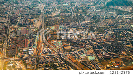Beijing, China. View From Airplane Window On Multi-story Buildings Of Beijing. Aerial View On Suburb. High-rise Houses Elevated View Cityscape Skyline. Urban Residential Area Overlooks To City. Real Beijing, China. View From Airplane Window On Multi-story Buildings Of Beijing. Aerial View On Suburb. High-rise Houses Elevated View Cityscape Skyline. Urban Residential Area Overlooks To City. Real 125142576