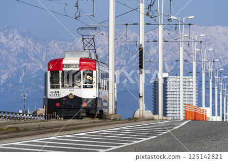 富山地方鐵道巡邏車穿越富山大橋,背景為立山山脈 富山地方鐵道巡邏車穿越富山大橋,背景為立山山脈 125142821