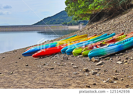 Colorful canoes lined up along the waterfront at Fukasaka Nature Park in Shimonoseki, Yamaguchi Prefecture Colorful canoes lined up along the waterfront at Fukasaka Nature Park in Shimonoseki, Yamaguchi Prefecture 125142936