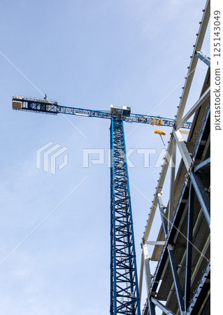 View of a Construction Crane with Steel Frame Building in the Background View of a Construction Crane with Steel Frame Building in the Background 125143049