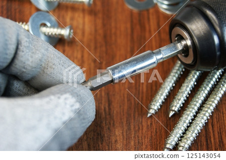 Removing the Torx bit from the bit adapter. Assembler's work process. 125143054