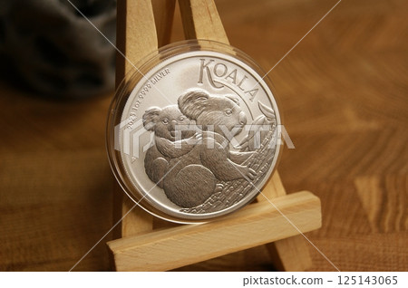 1 dollar 1 Oz Koala 2023 Australian pure silver coin in capsule. Close up. 1 dollar 1 Oz Koala 2023 Australian pure silver coin in capsule. Close up. 125143065