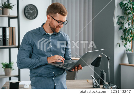 Man is working in the modern office. Conception of business and freelance Man is working in the modern office. Conception of business and freelance 125143247
