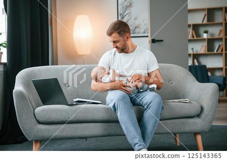 Father with toddler is at home, taking care of his son 125143365