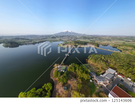 Aerial view of Tsuru no Mai Bridge and Mount Iwaki in Aomori Prefecture, Tsuruta Town 125143606