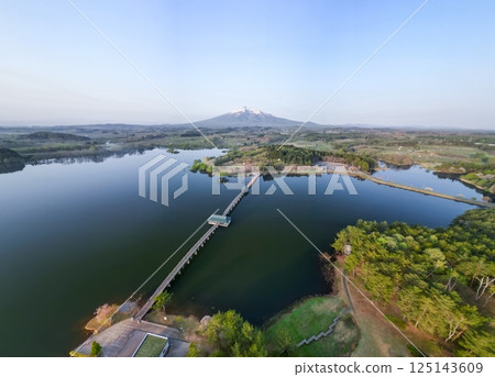 Aerial view of Tsuru no Mai Bridge and Mount Iwaki in Aomori Prefecture, Tsuruta Town 125143609