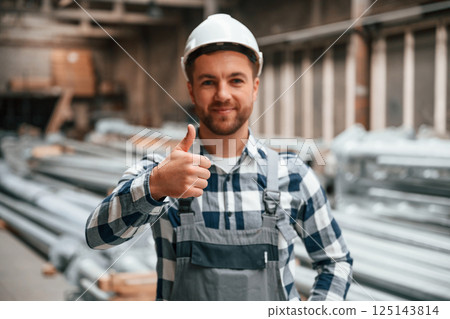 Friendly factory male worker in uniform is indoors Friendly factory male worker in uniform is indoors 125143814